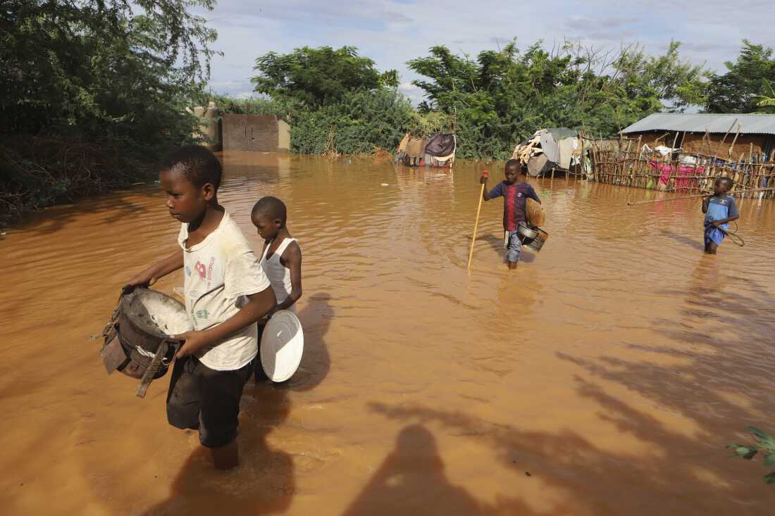 Children flee the floodwaters that wreaked havoc in Kenya in April. The impact of catastrophic rains that hit East Africa from March to May were exacerbated by a combination of climate change and rapid urban growth, an international team of climate scientists said in a study.