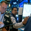 Stocks and cryptocurrencies rose after former President Trump won the presidential election. Pictured are traders working at the New York Stock Exchange in New York on October 22.