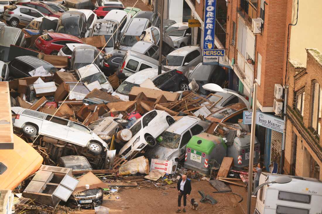 Cars are piled up in the street with other debris in Valencia, Spain, after flash floods in October. Scientists from a group called World Weather Attribution said the floods were caused by 12% heavier rainfall and more likely to be doubled by climate change.