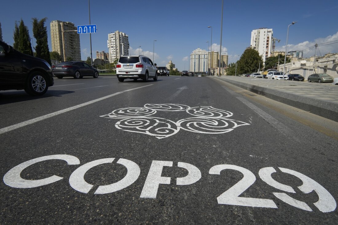 The COP29 climate change conference logo is painted on a road in Baku, Azerbaijan.